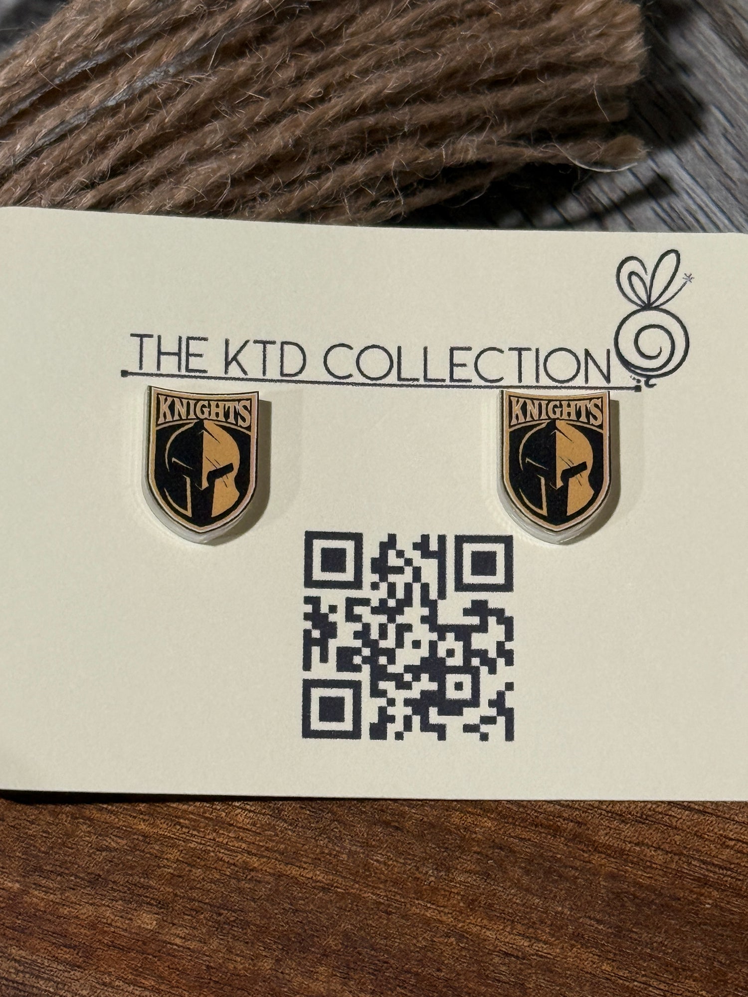 Pair of UV-printed acrylic stud earrings featuring the Canandaigua Knights logo, mounted on The KTD Collection backing card