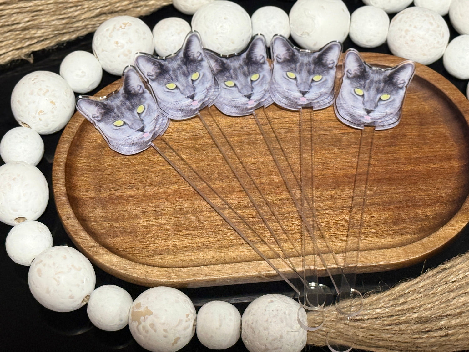 Custom acrylic drink stirrers with UV printed pet photos and logos, displayed in clear glasses with party decor in background