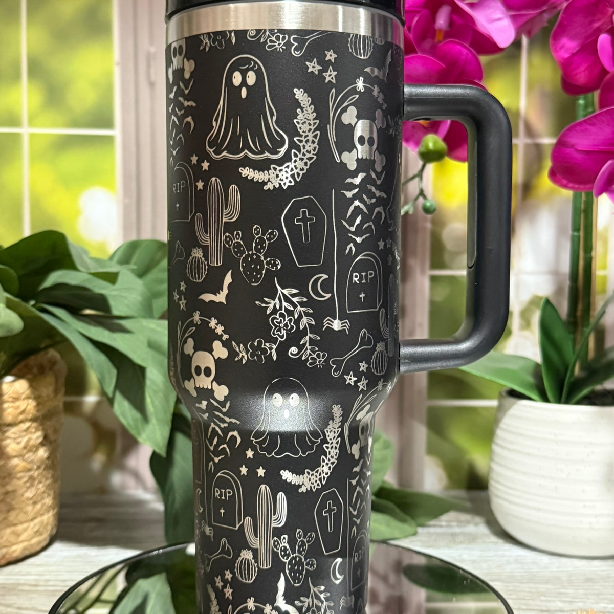 40oz black stainless steel tumbler with handle, laser engraved with Halloween ghost doodles, skulls, gravestones, and stars – ready to ship.