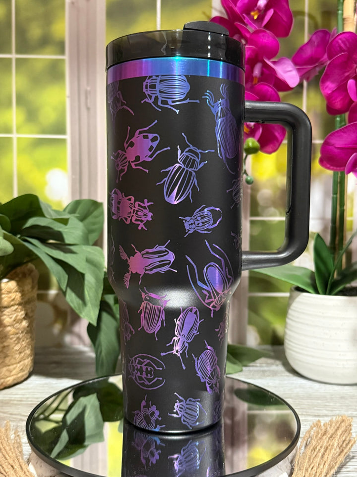 40oz chromatic black tumbler with handle, laser engraved with bug and beetle designs, featuring rainbow chrome accent – ready to ship.