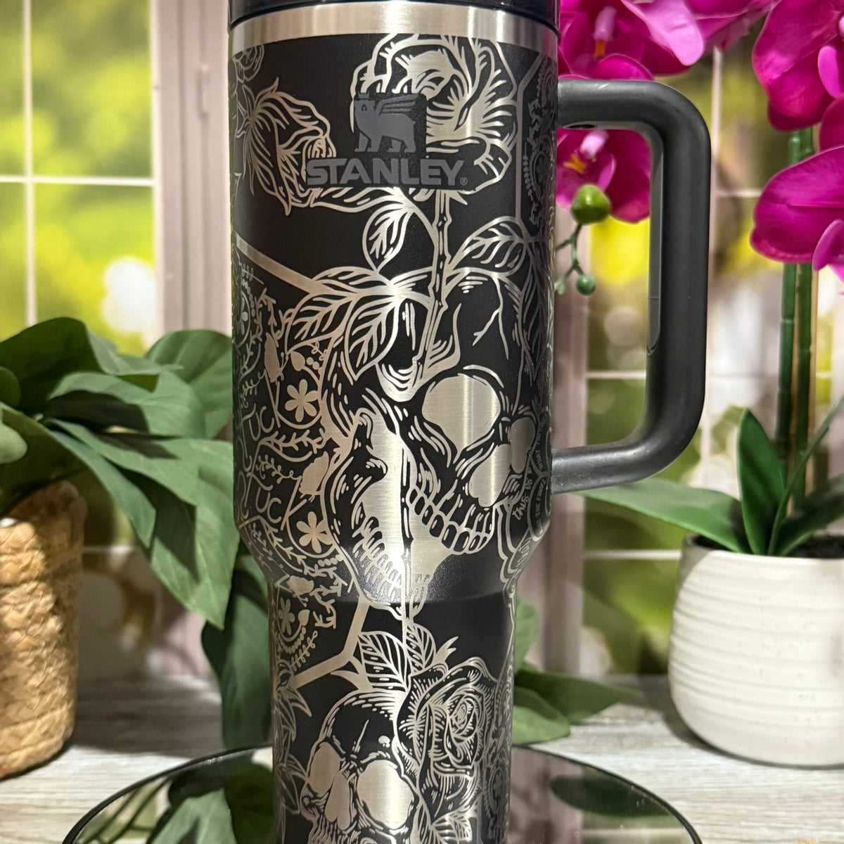40oz Black Stanley tumbler cup with handle, laser engraved with Skulls & Cuss Words design including skulls, roses, and hidden text – ready to ship.