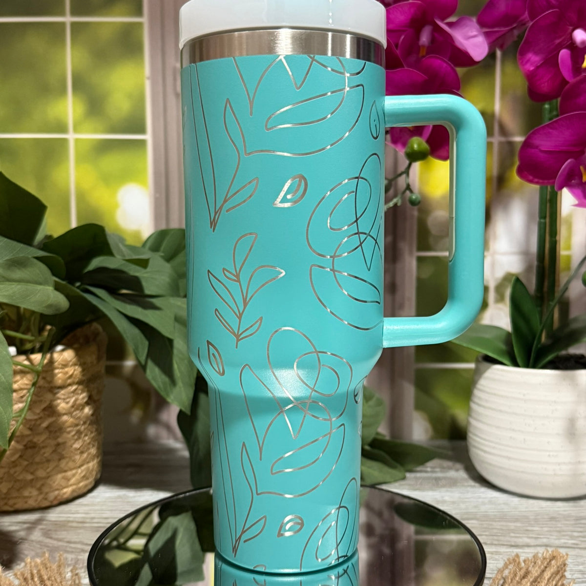 40oz teal stainless steel tumbler cup with handle, laser engraved with abstract floral line art design – ready to ship.