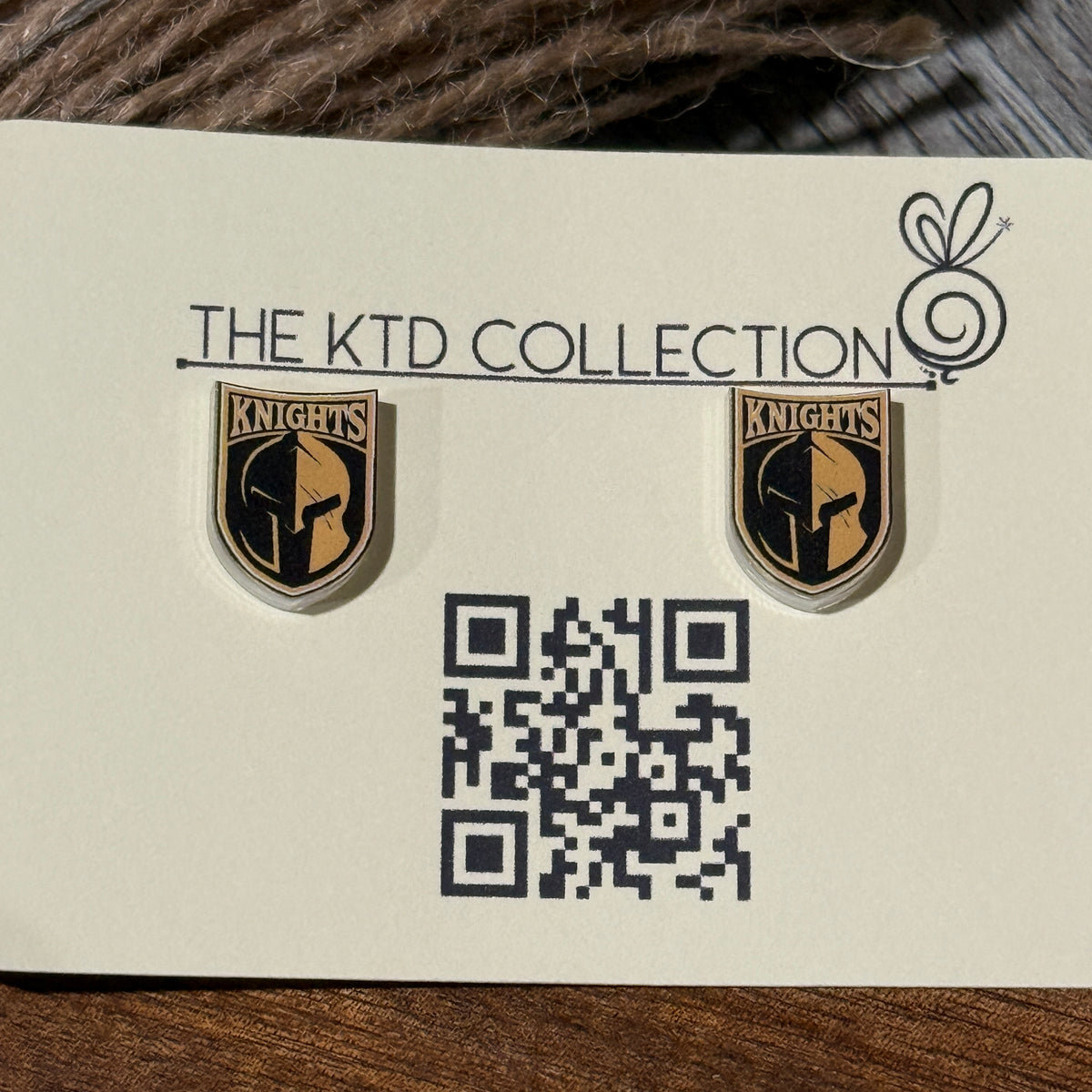 Pair of UV-printed acrylic stud earrings featuring the Canandaigua Knights logo, mounted on The KTD Collection backing card