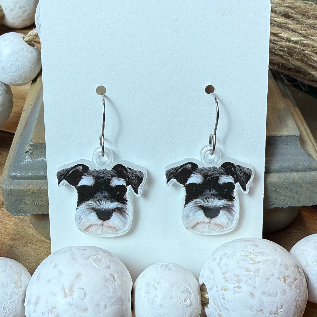 Custom pet portrait earrings made from a photo of a dog, UV printed on clear acrylic with earring hardware attached