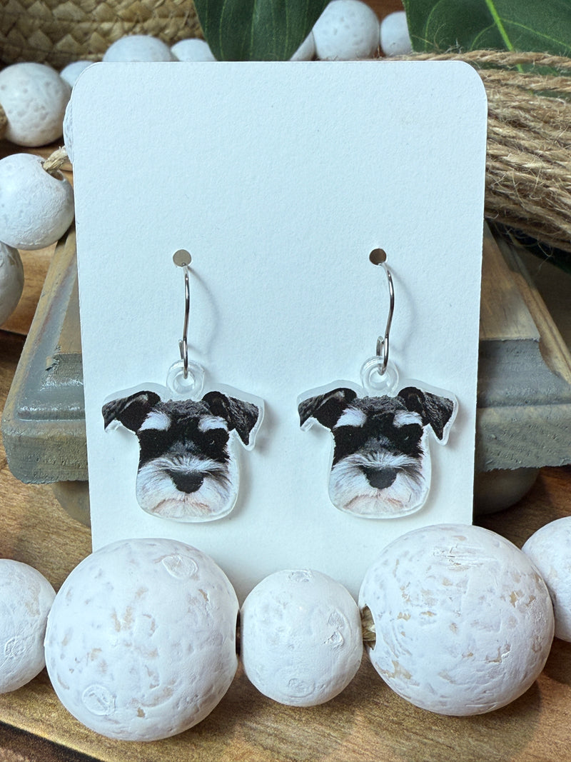 Custom pet portrait earrings made from a photo of a dog, UV printed on clear acrylic with earring hardware attached