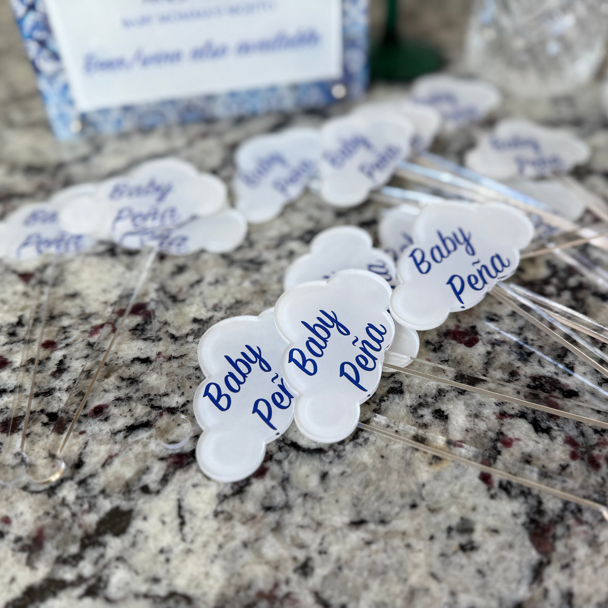 Acrylic drink stir sticks printed with custom images, shown on a granite counter
