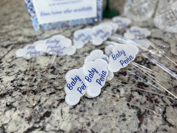 Acrylic drink stir sticks printed with custom images, shown on a granite counter