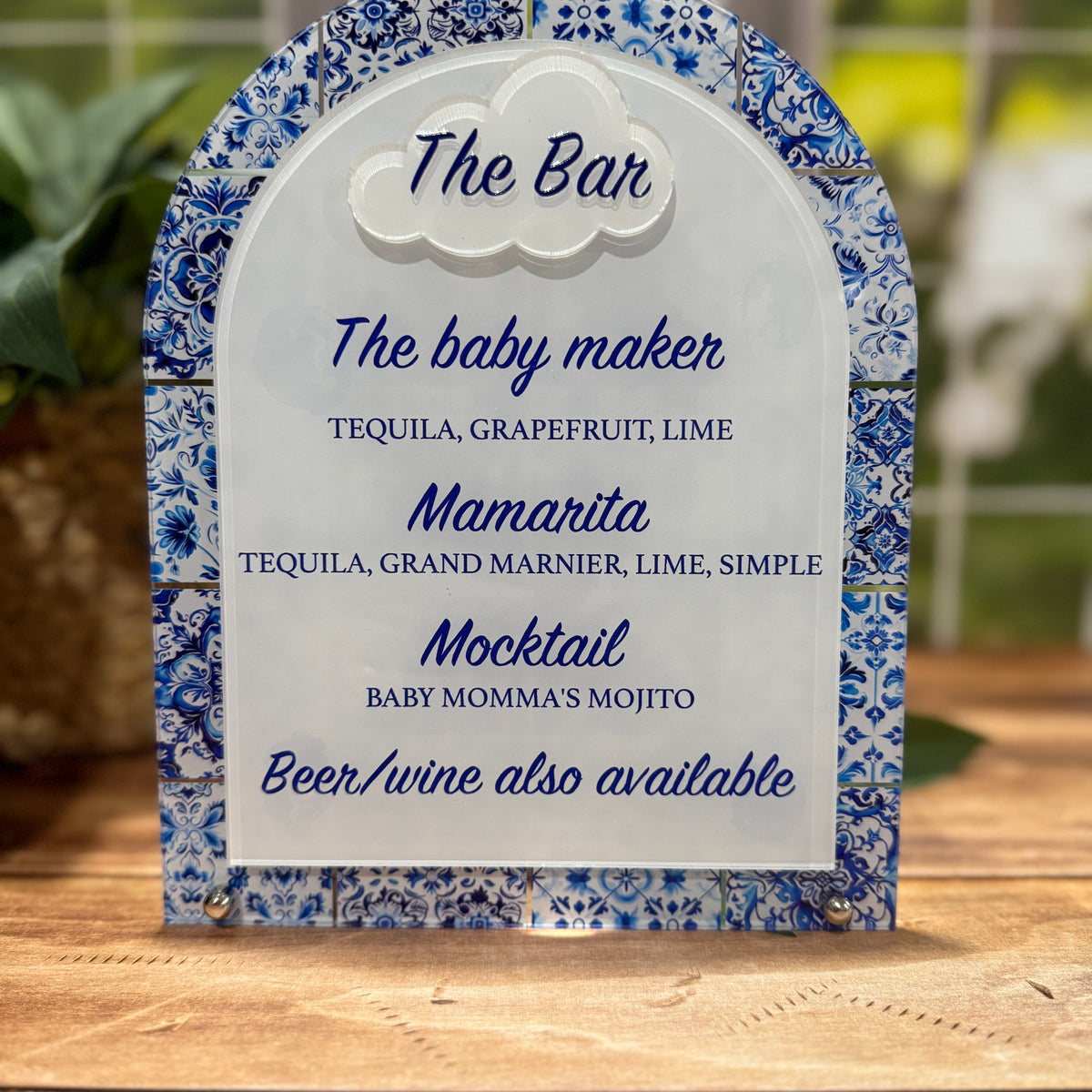 Decorative bar menu with blue floral design on a wooden surface