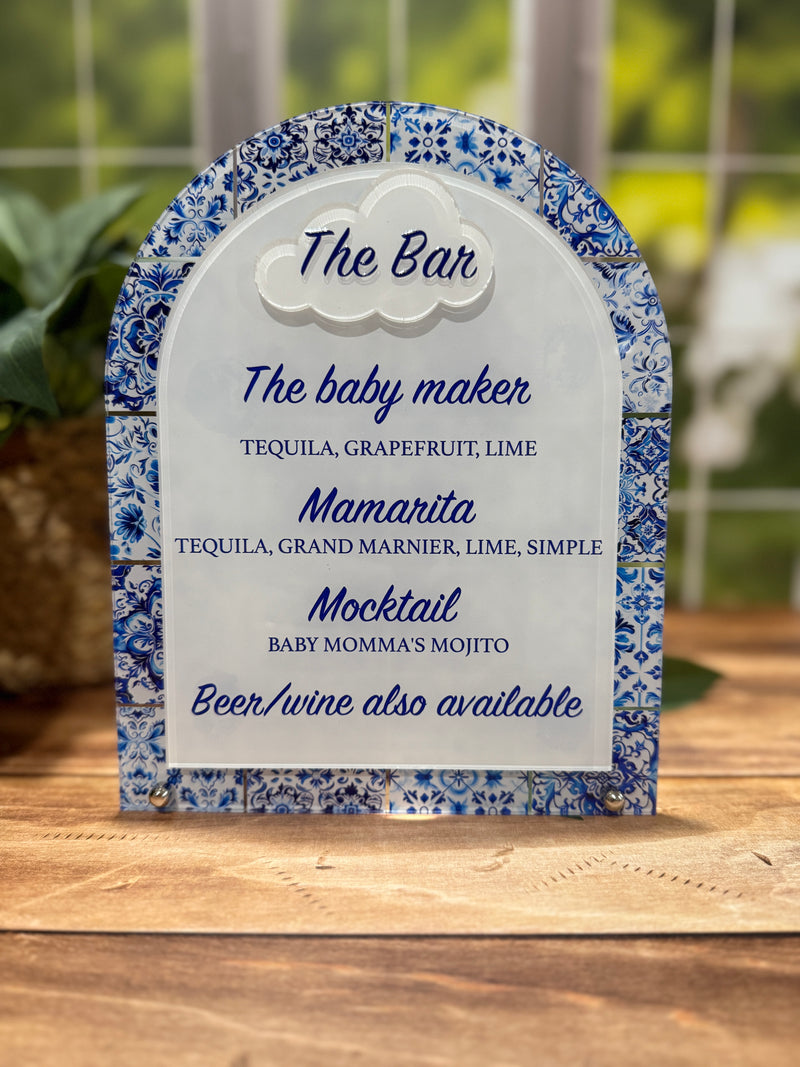Decorative bar menu with blue floral design on a wooden surface
