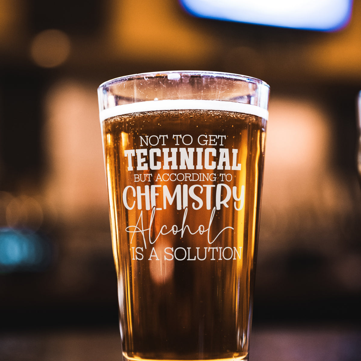 Laser engraved alcohol-themed pint glass with funny saying, displayed on wood surface—perfect gift for men, groomsmen, or beer enthusiasts