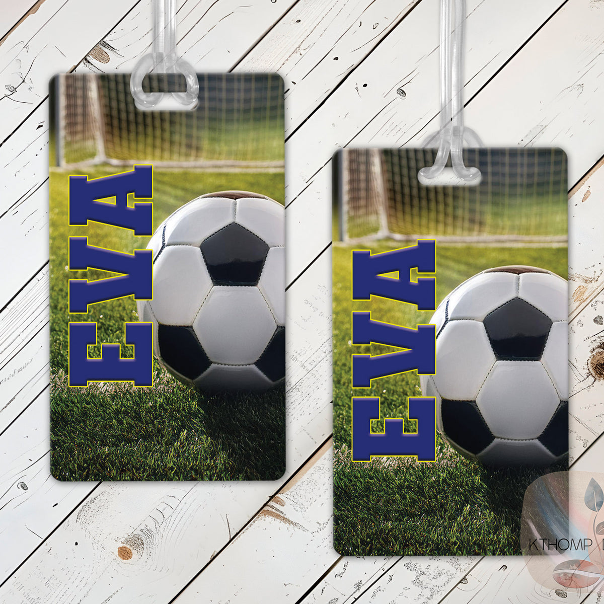 Personalized soccer bag tags with player name and number shown on a wood background