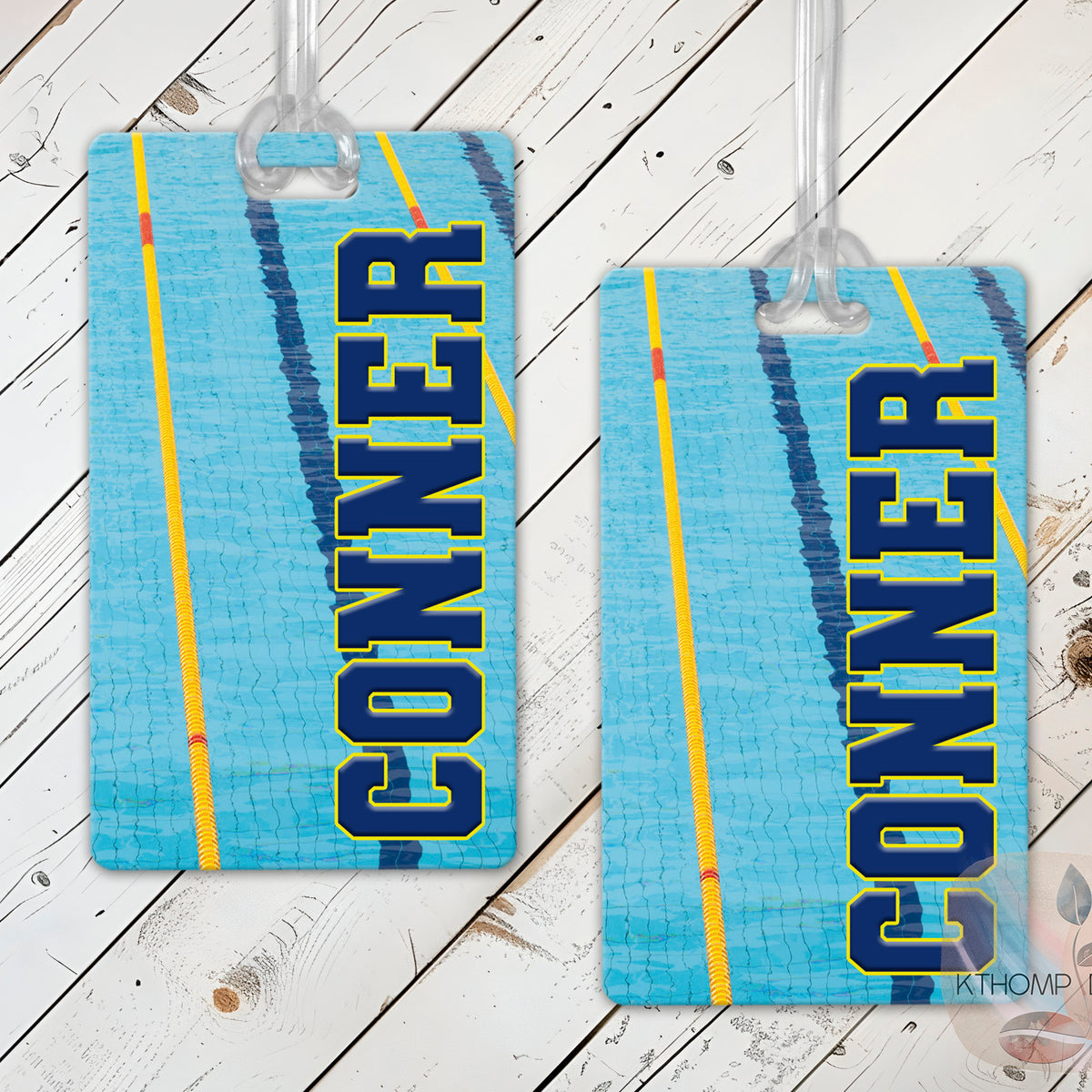 Swimming bag tags with name and swimmer graphic on a wood background