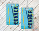 Swimming bag tags with name and swimmer graphic on a wood background