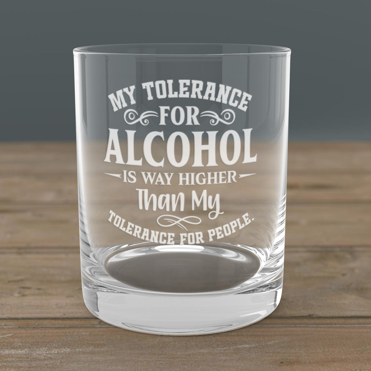 Laser engraved alcohol-themed whiskey glass with bold saying, placed on a wood bar—perfect gift for men, groomsmen, or bourbon enthusiasts