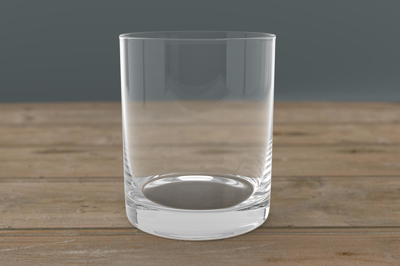 Laser engraved whiskey glass with alcohol-themed quote, set on bar cart