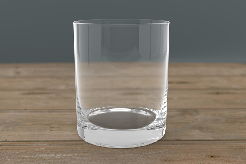 Laser engraved whiskey glass with alcohol-themed quote, set on bar cart